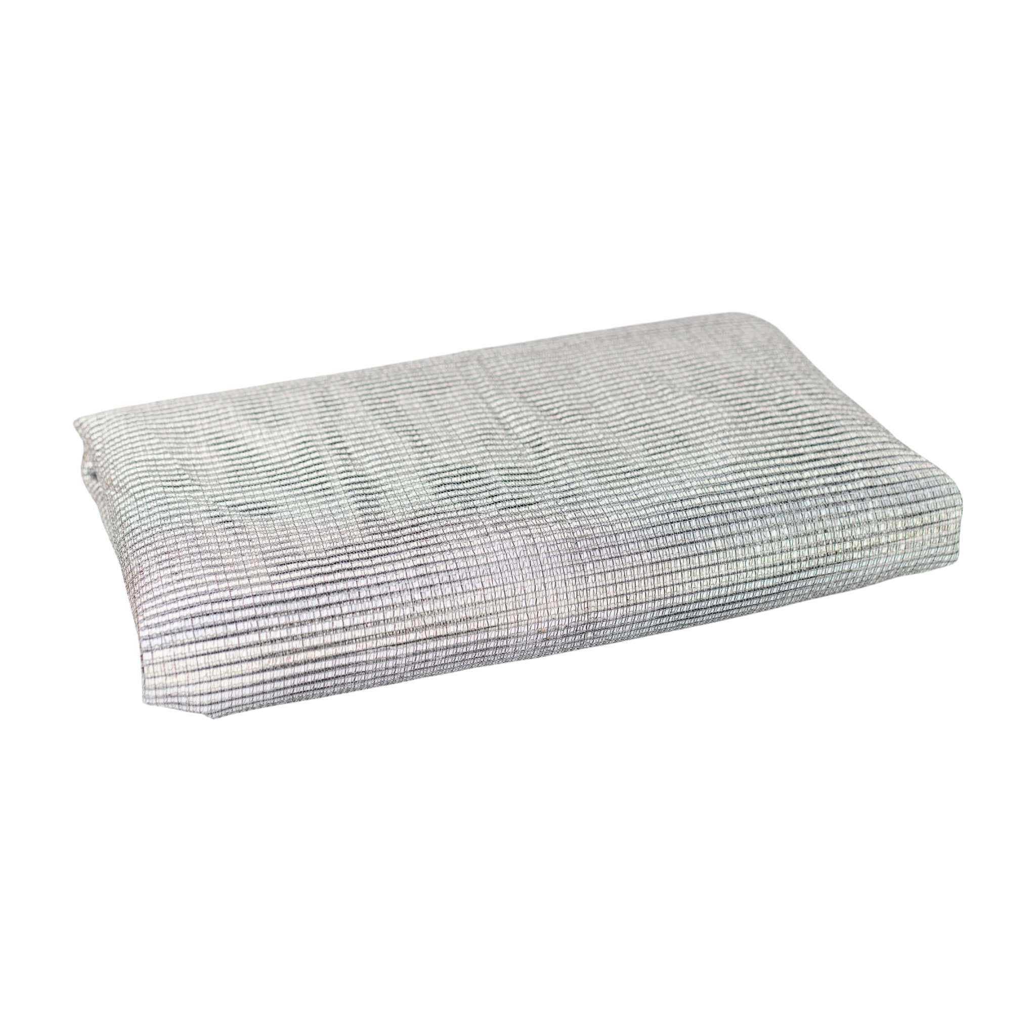 White aluminum greenhouse shade cloth folded on a neutral background
