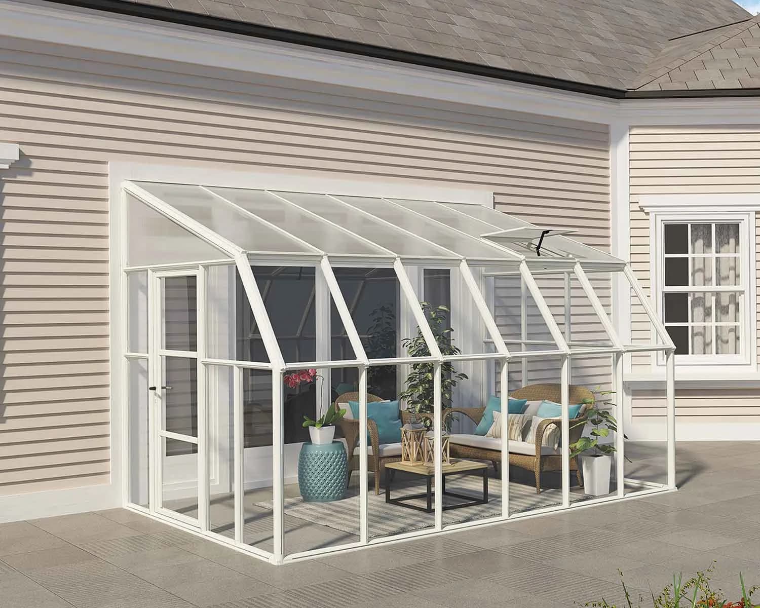 White Rion Sun Room lean-to sunroom attached to a house wall with patio furniture inside